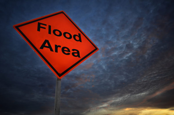 Flood Area warning road sign with storm background