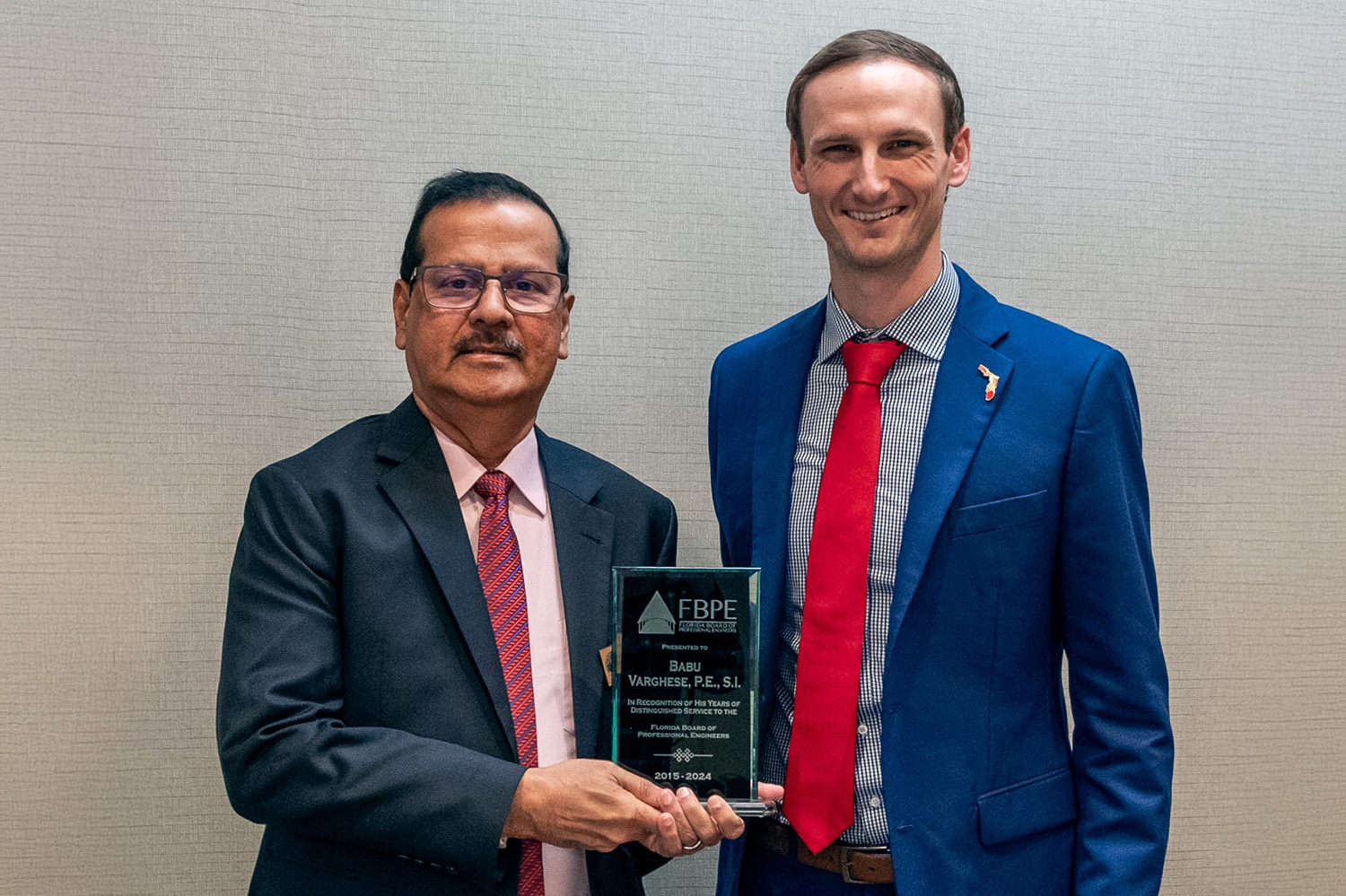 Dylan Albergo, PE, (right) FBPE Chair (2024), presents Babu Varghese, PE, SI, with a plaque honoring him for his service on the Board.